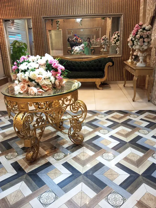 Gold scrollwork table with a rose centrepiece