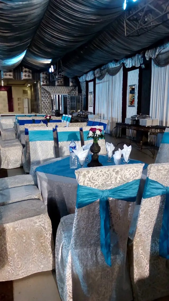 Tables dressed in blue with folded napkins