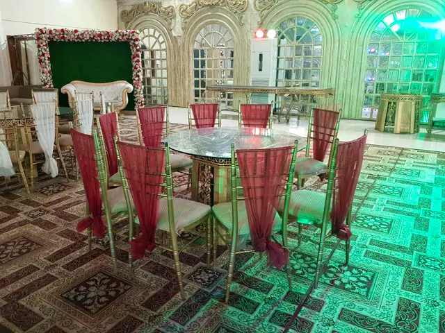 Round table set with red chair sashes