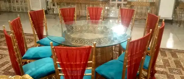 Glass table with red and teal chairs