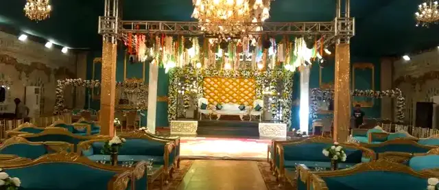 Teal hall with chandeliers and lounge seating