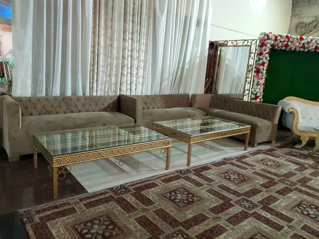 Beige sofa lounge beside a green flower wall