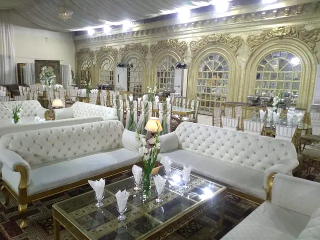 White tufted sofas around glass tables