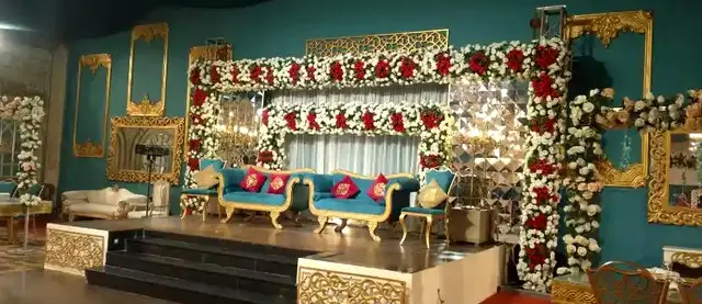 Red rose and white flower stage in the teal hall